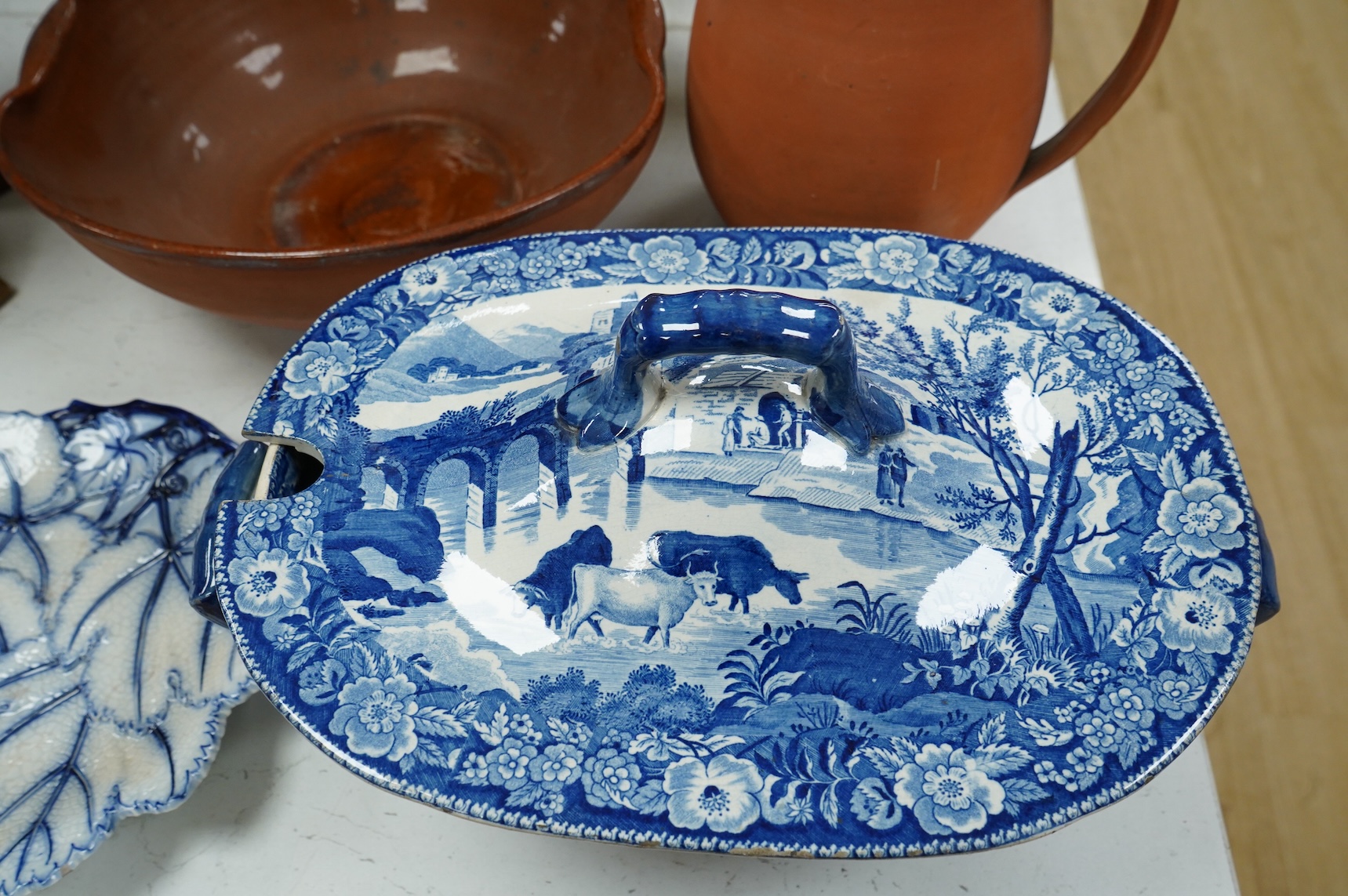 An early 19th century pearlware tureen, a pair of pearlware leaf dishes, a glazed earthenware jug and basin